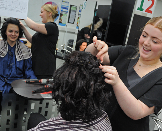 Hairdressing student wiht real life client in salon