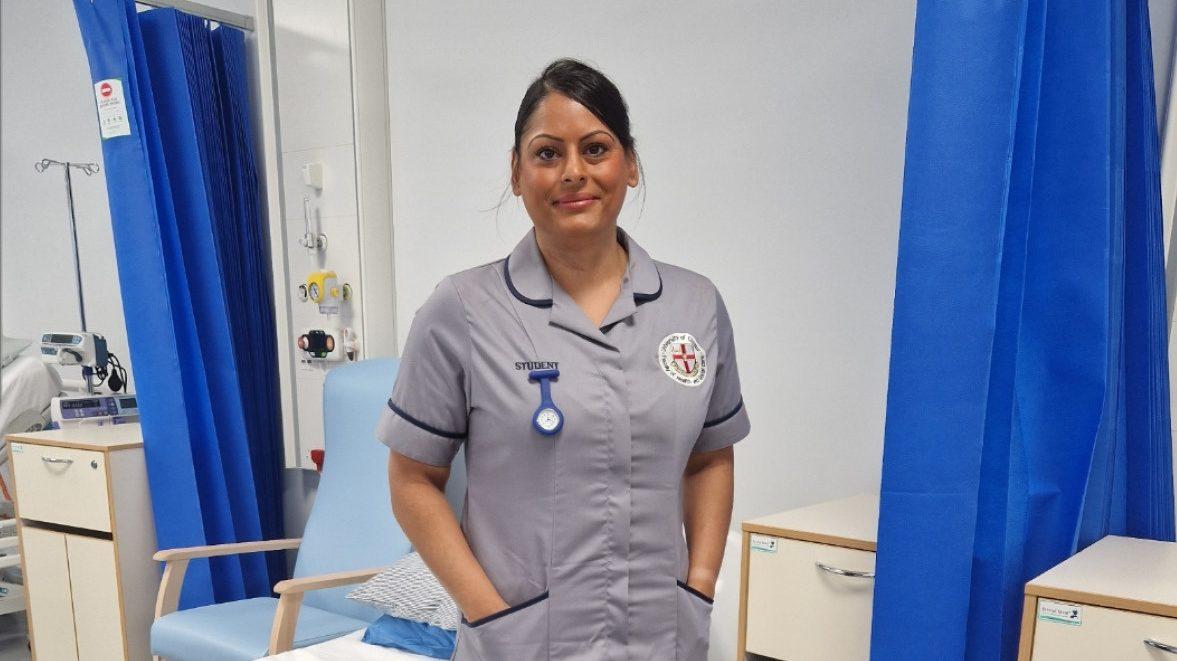 Access to HE Nurse standing infront of hospital bed