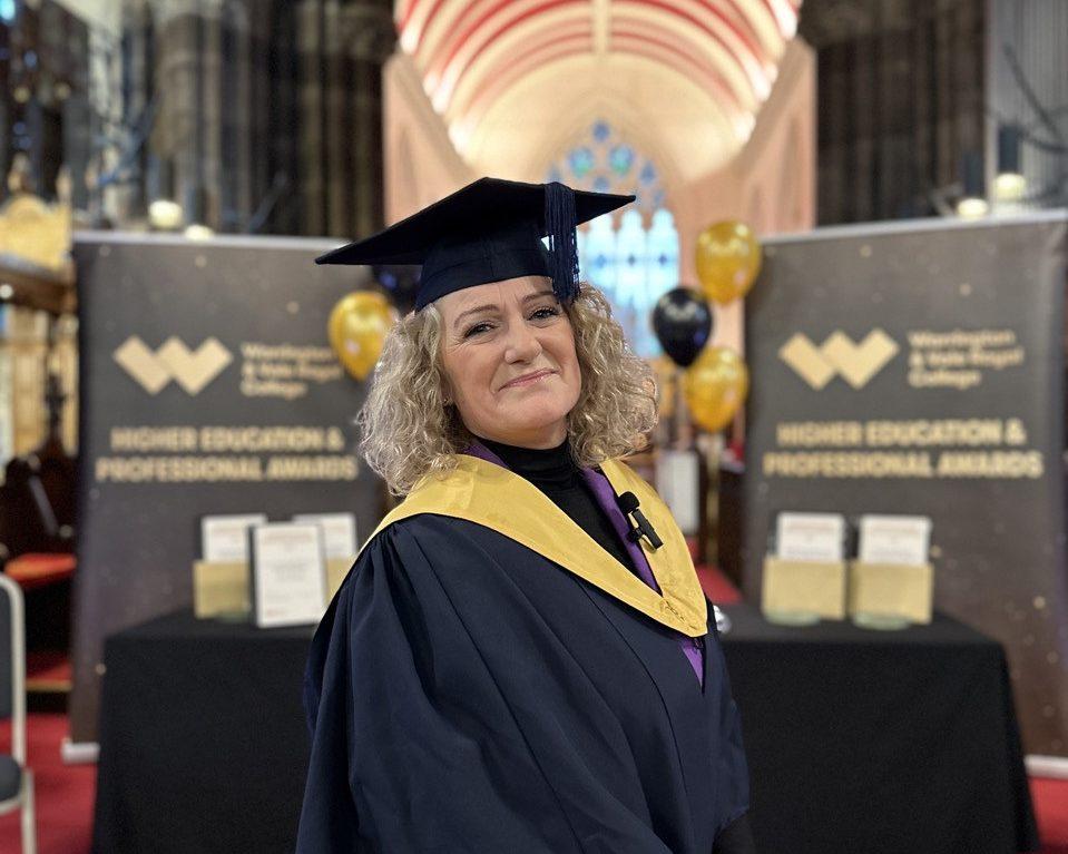 Amanda Fryer in Cap and Gown with a church background