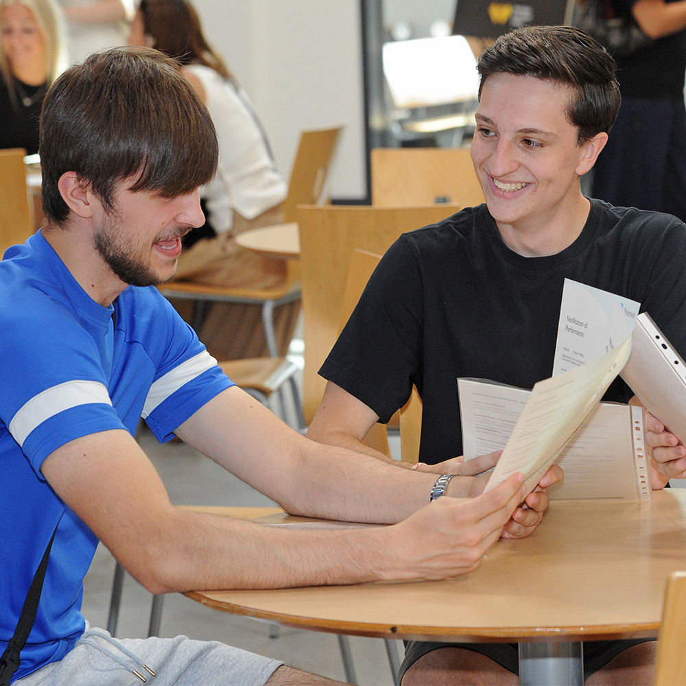 Friends compare their certificates