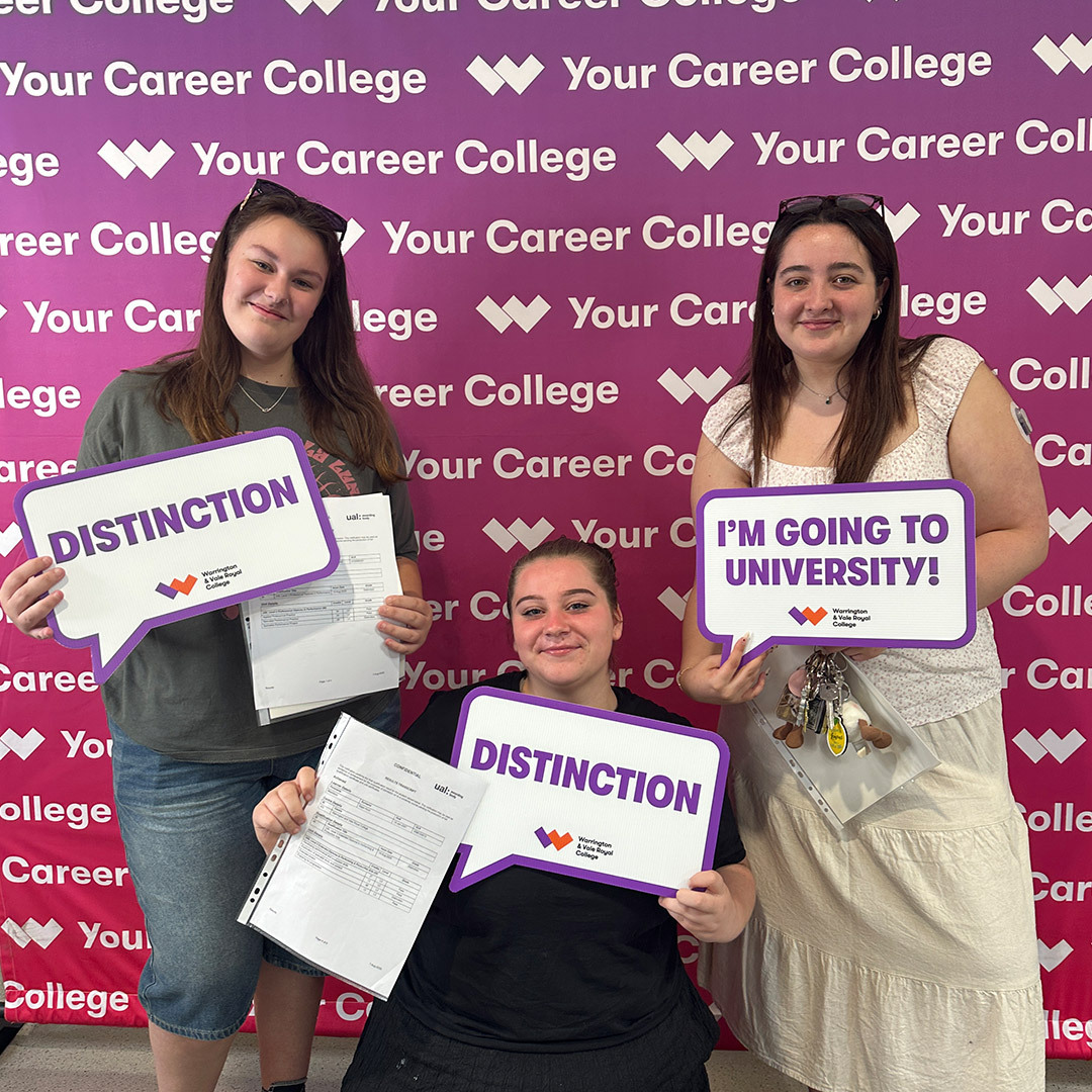 Performing arts students hold signs with their grades