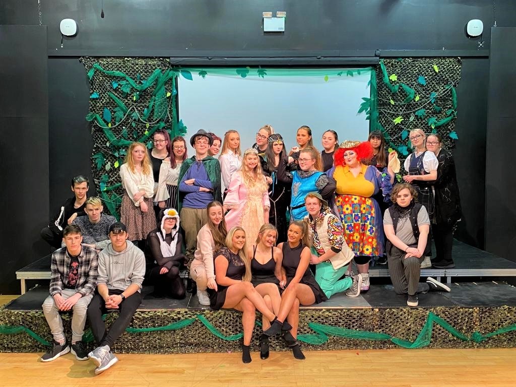 Performing arts students posing on stage