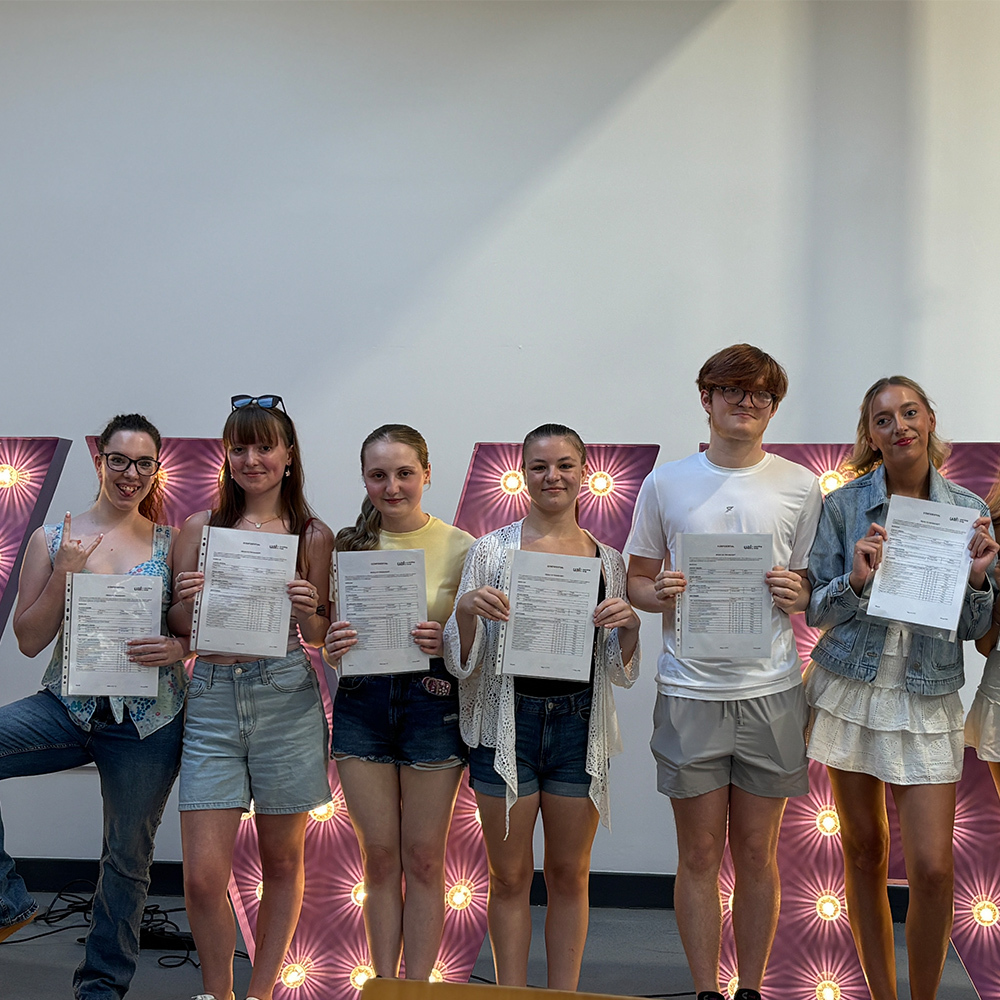 Performing arts students post with their results