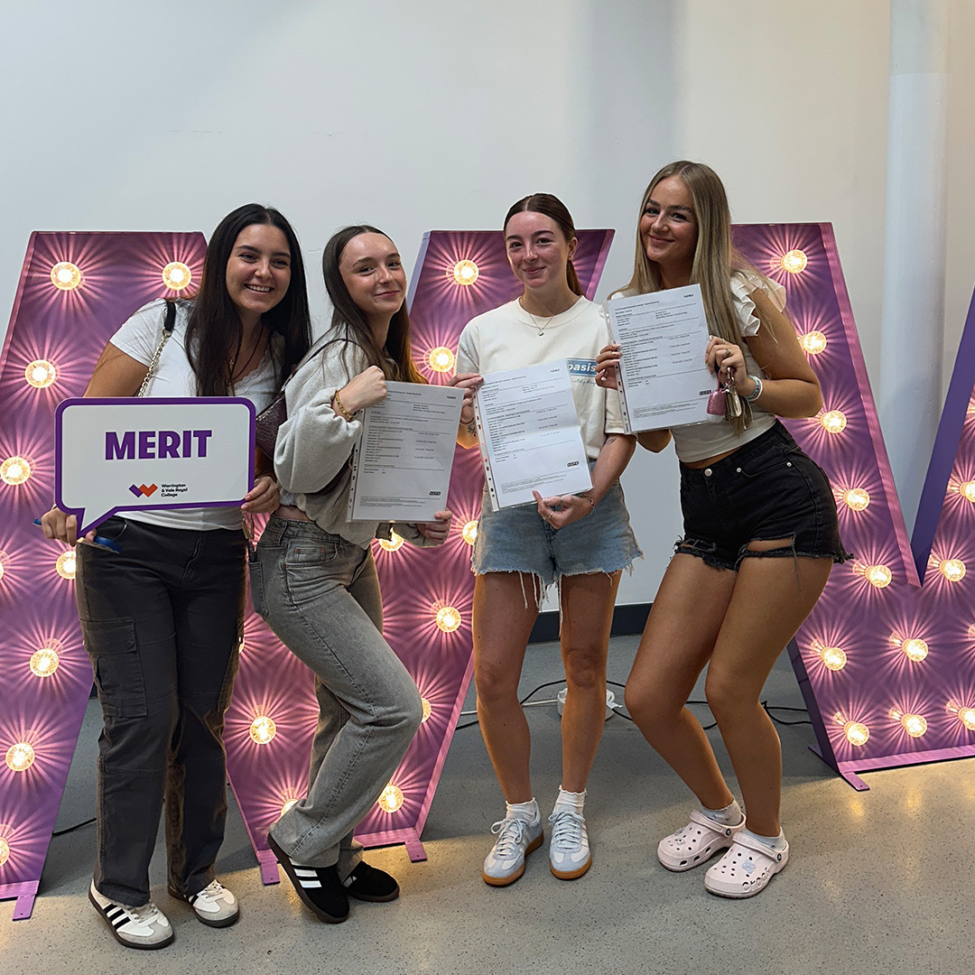 Proud students show their results for the camera