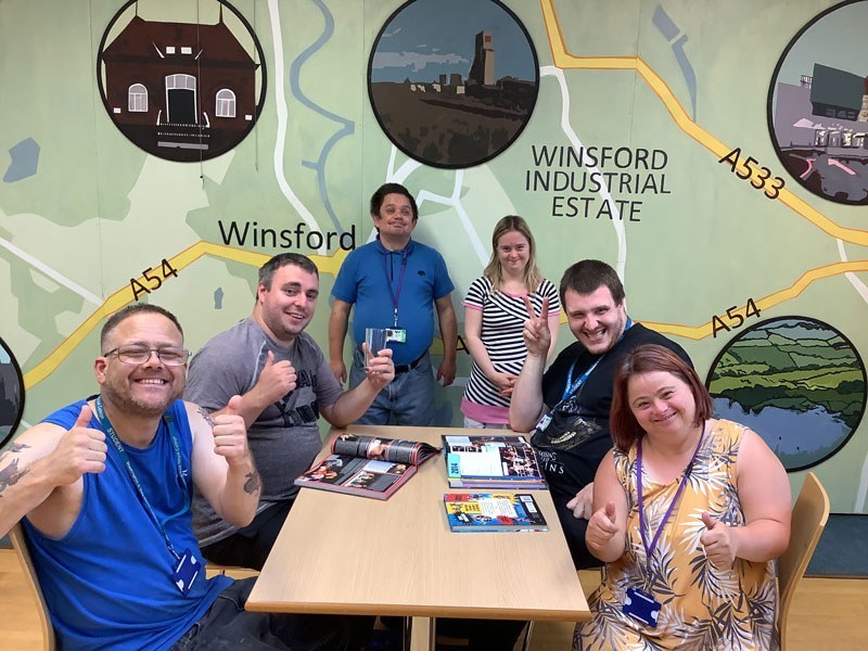 Personal & Social Development students sitting around a table smiling