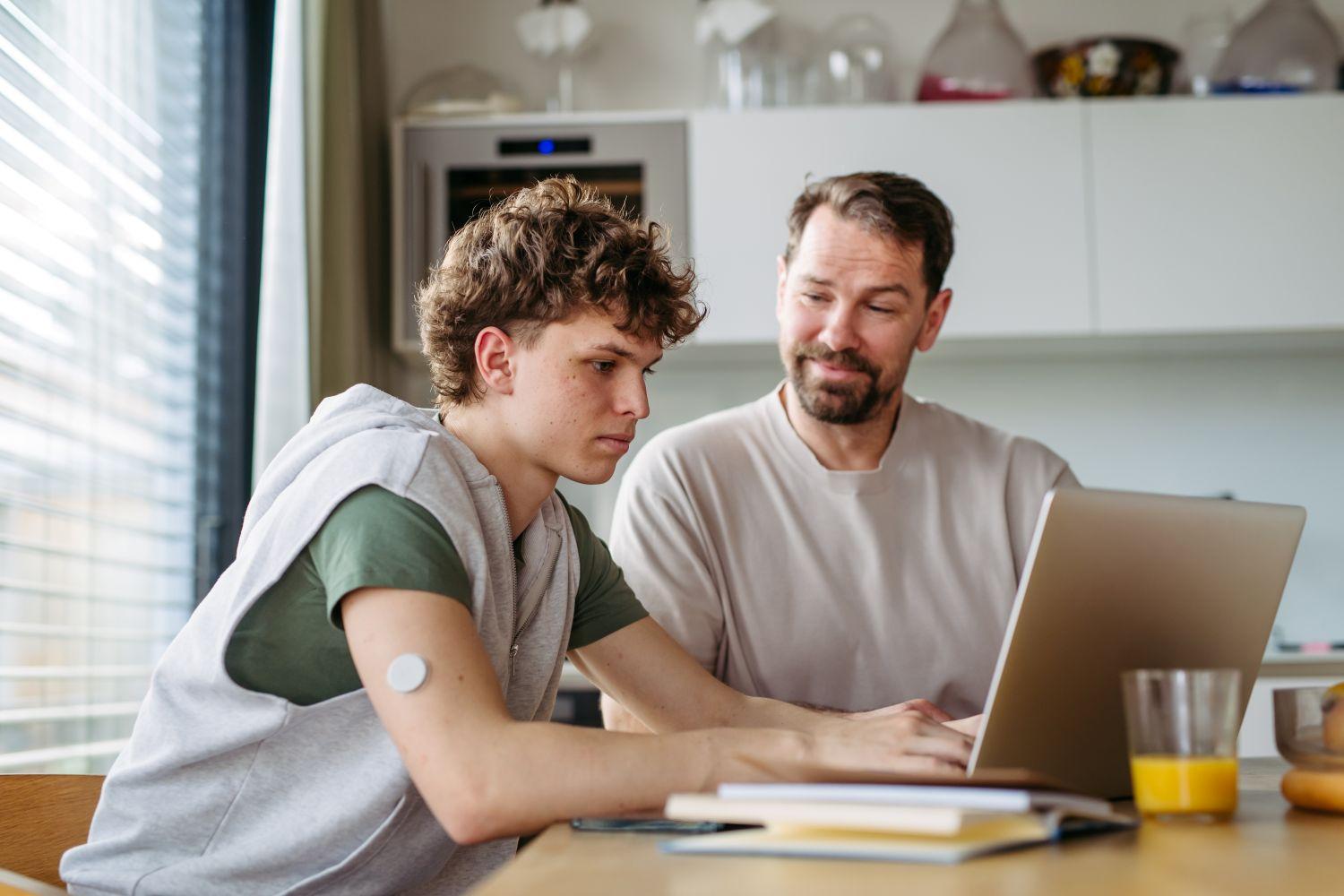 Stduent and father career planning using laptop