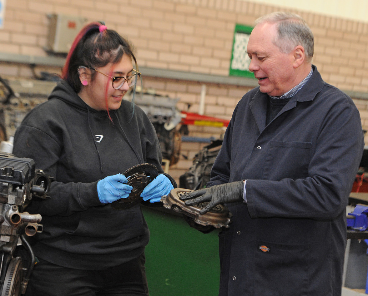Student and tutor in motor vehicle workshop