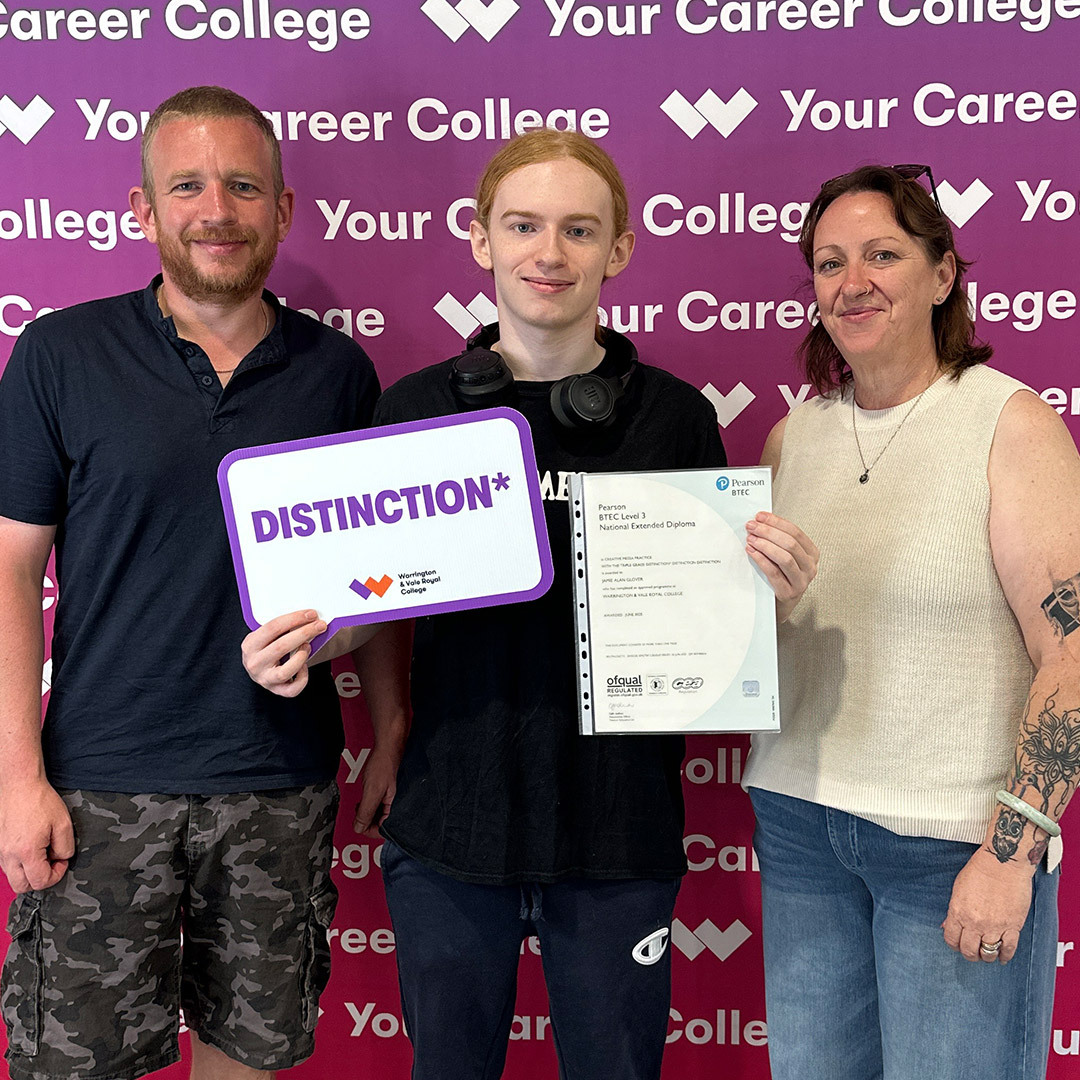 Student poses with proud parents and his grade