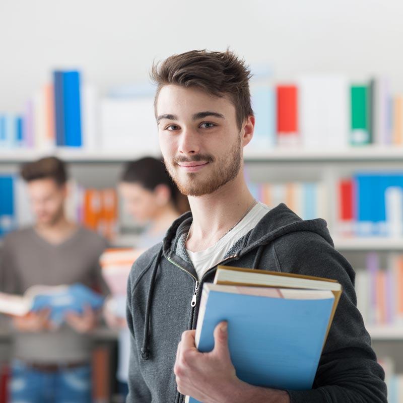 Student posing holding books