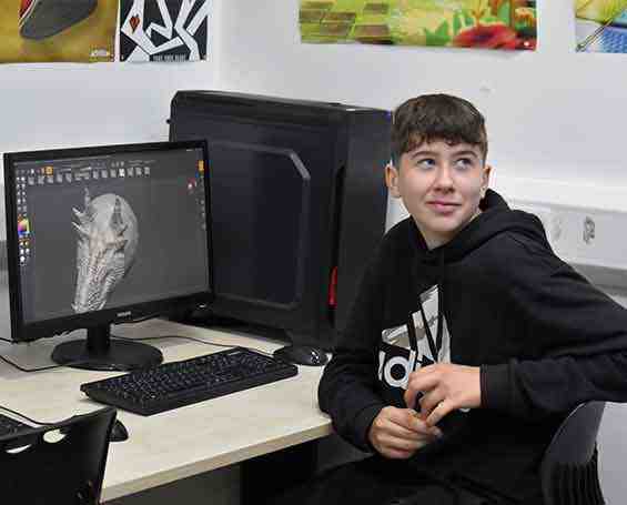 Student sat at computer using gaming software