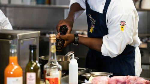 Student seasoning food - Buckleys webpage