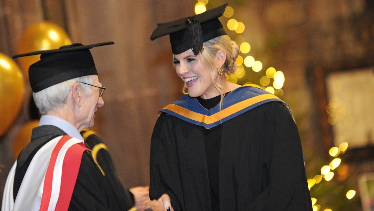 Student shaking Mervyns hand