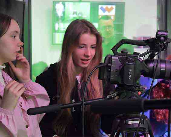 Students operating specialist cameras in the TV studio