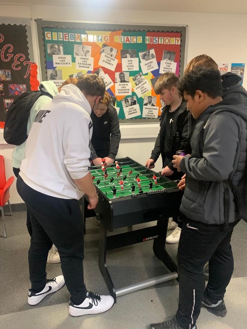 Students playing table football