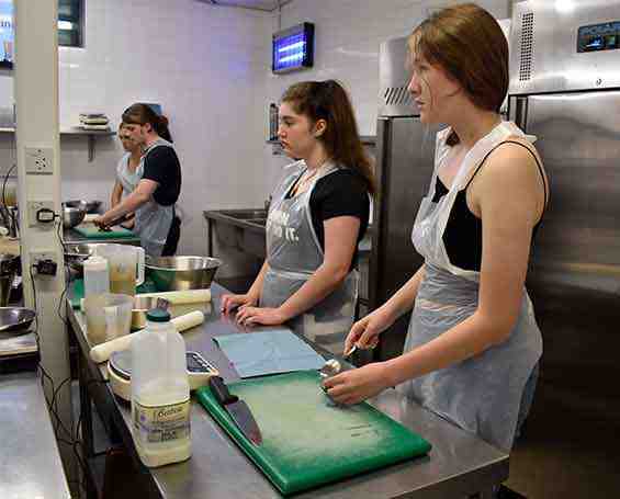 Students preparig food in ktichens