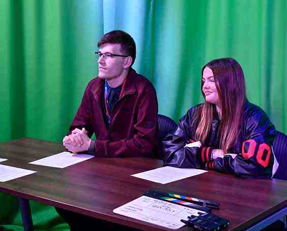 Students recording a podcast in the TV studio