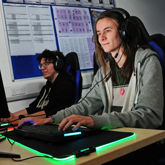 Games design student sitting at specialist PC