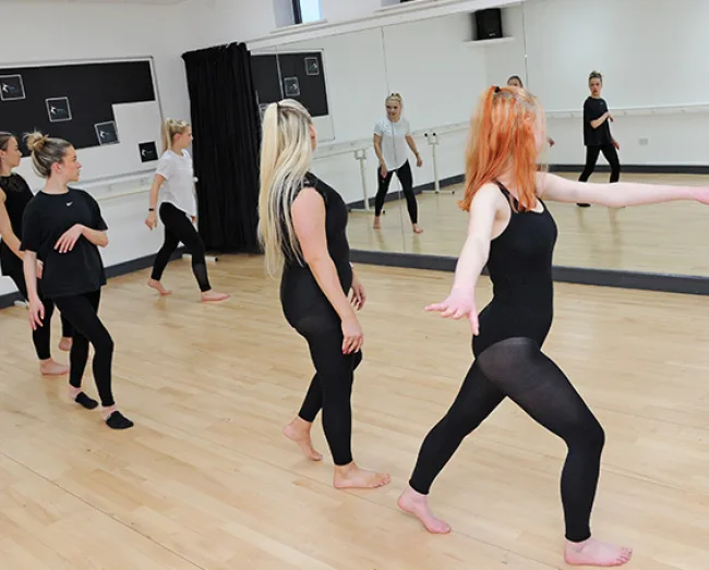 Dance students rehearsing in dance studio