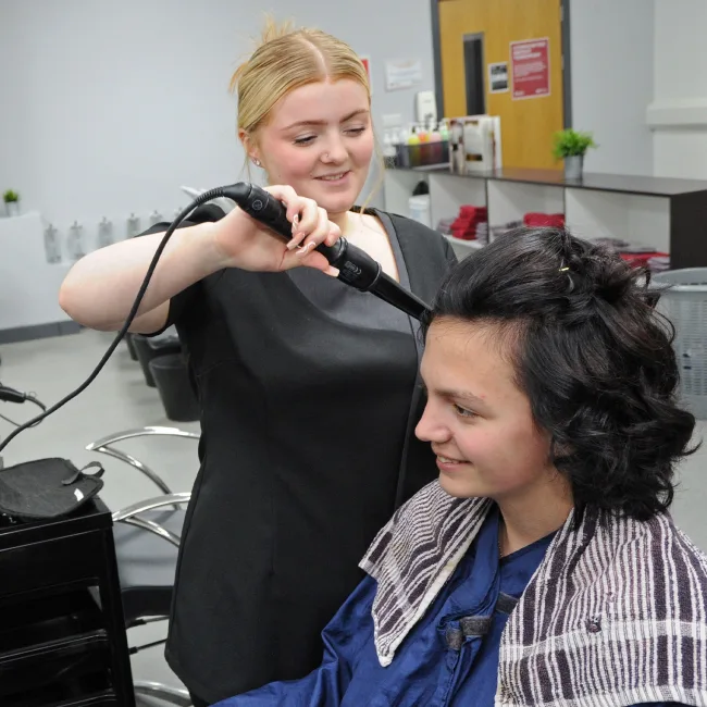 Hairdressing student working on client