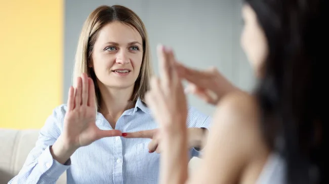 two students learning sign language