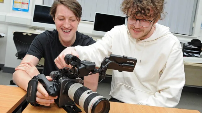 Two photography students using professional camera