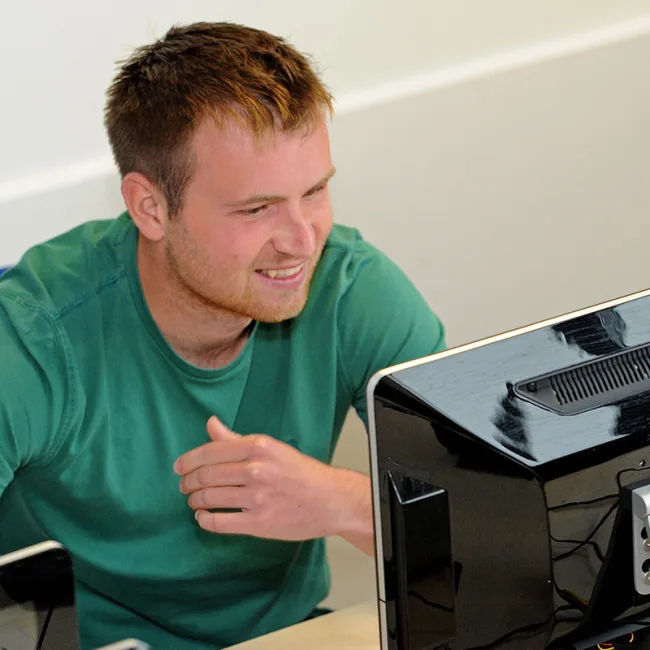 Older male student working on computer