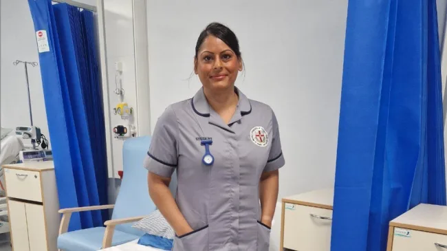 Access to HE Nurse standing infront of hospital bed