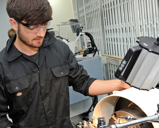 Engineering student using milling machine