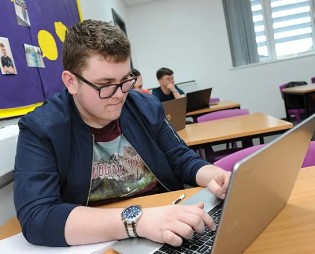Smart looking student working on a laptop