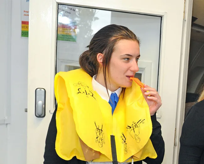 Travel & Tourism student inflating life jacket