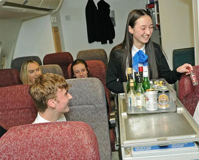 Travel & Tourism students in simulation plane fuselage