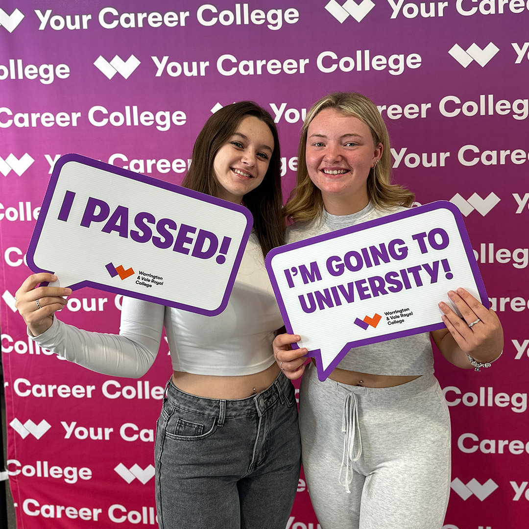 Two students hold up signs at the con grad ulations station